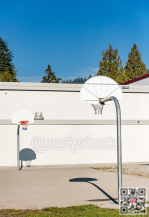 Basketball court with two baskets on school back yard