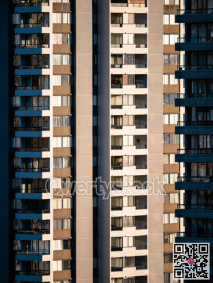 Facade of residential high-rise towers on bright sunny day