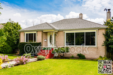Modest family house with green lawn in front