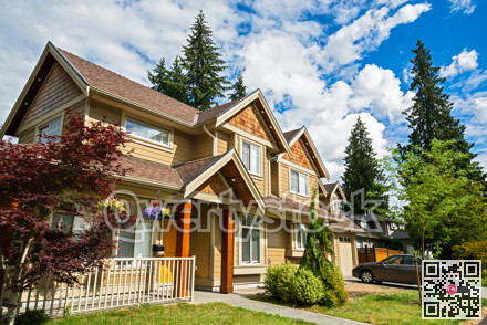 Luxury residential house with car parked in front on cloudy sky background