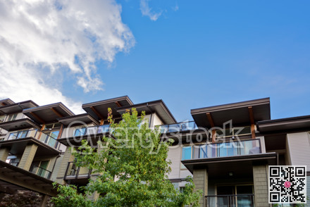 Raising roofs of residential building on blue sky backdrop