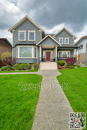 Nice family house with concrete pathway over green lawn over front yard