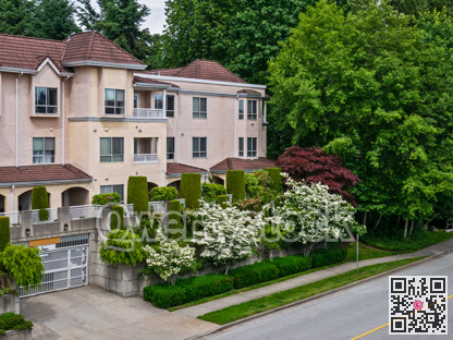 Italian style low-rise residential building with decorative trees in front
