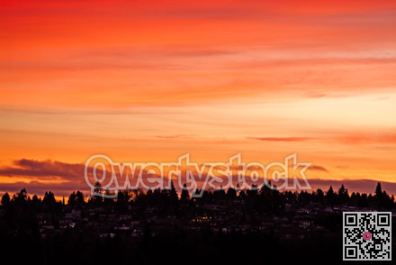 Suburban residential area on sunset sky background