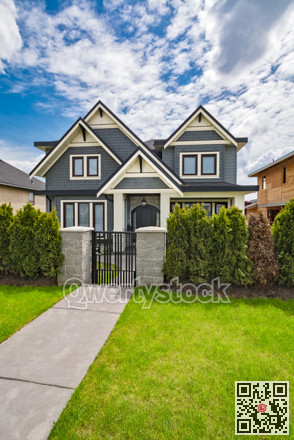Residential family house with concrete pathway over green lawn on the front yard