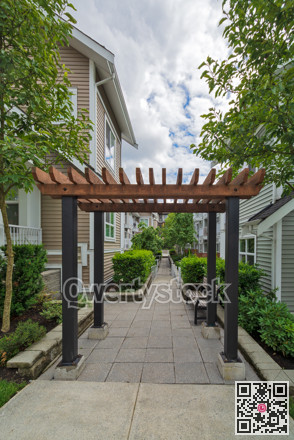 Pathway in residential area between two rows of townhouses.