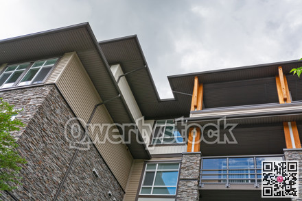 Residential building roof silhouette on overcast sky background