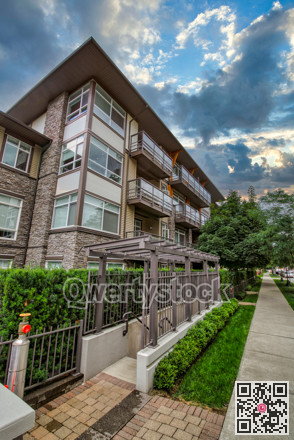Corner of residential building on cloudy sky background