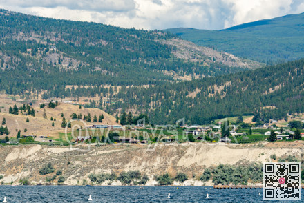 Beautiful view over Okanagan lake with mountains and clouds on background