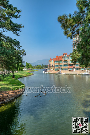 Ducks in front of luxury residential area with boat pier at the entrance