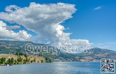 Okanagan lake and mountains overview on cloudy sky background