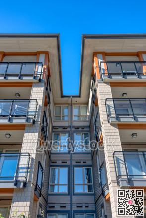 Top levels of new residential building on blue sky background