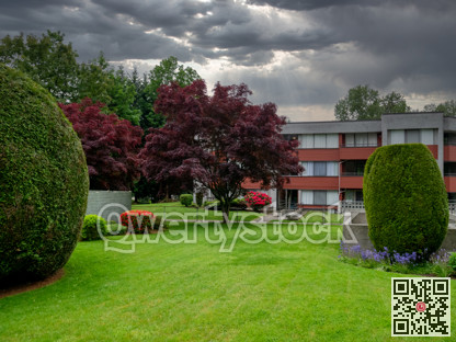 Residential apartment building on stormy sky background