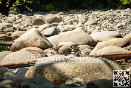 Small stone tower on dried waterway of montailn river