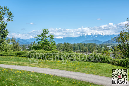 Riverbank walkway with overview of snow caps on Rocky mountains
