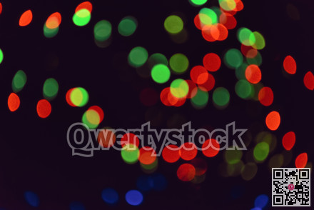 Colorful group of holiday lights on dark background of the night