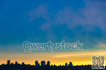Town center on sunset cloudy sky background closer to the night