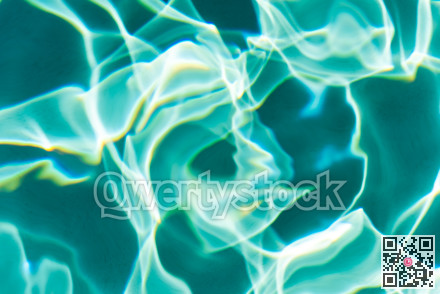 Sunflecks on emerald water surface in a swiming pool