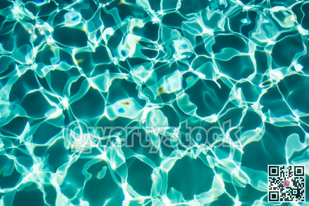 Sunflecks on emerald water surface in a swiming pool