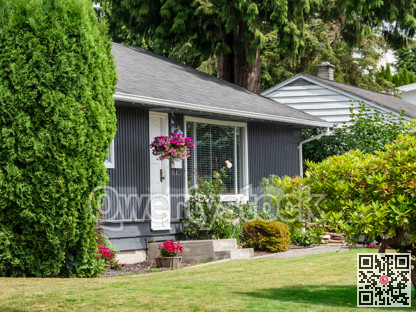 Main entrance and living room window of residential house green lawn in front