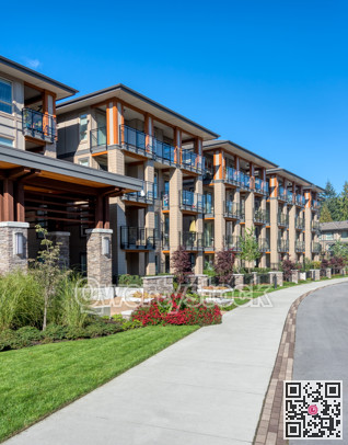 Residential apartment buildings on blue sky background with concrete pathway