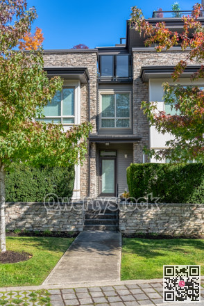 Entrance of residential townhouse with paved pathway in front