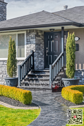 Entrance of family residential house on sunny day on cloudy sky background