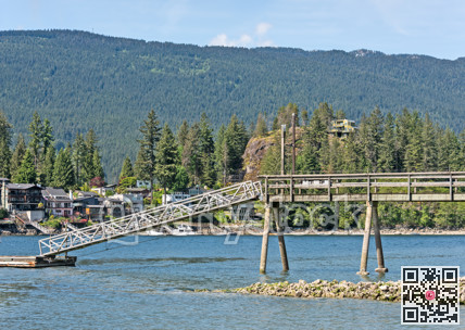 Ocean bay shore overview with residential houses on mountain background