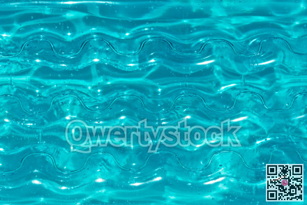 Texture of inflatable aqua color mattress on the water