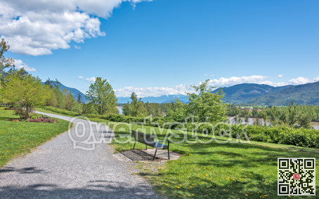 Riverbank walkway with overview of snow caps on Rocky mountains