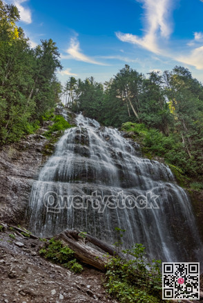 Bridal fall in a deep forest on bright summer day
