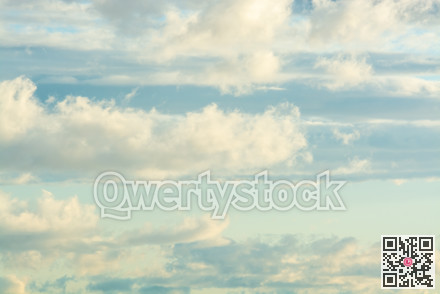 White airy clouds in yellow sunset light