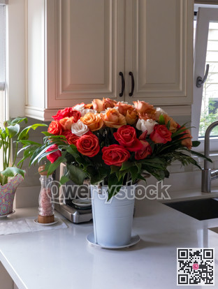 Bouquet of beautiful roses on the marble table in a kitchen