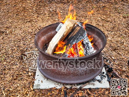 Campfire in a steel wheel on the concrete base