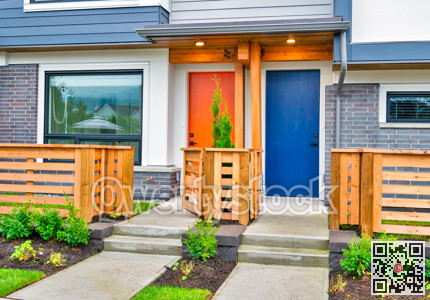 Orange and blue doors of brand new residential townhouses