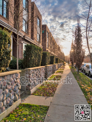 Sidewalk along townhouses on autumn season in Queensborough community