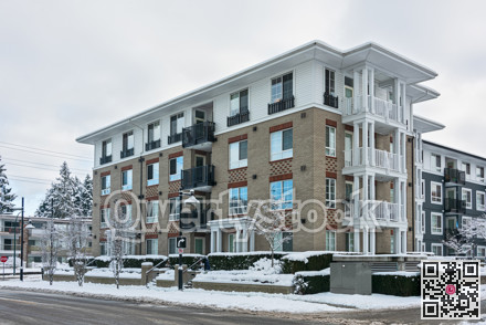 Residential low-rise building on winter day with white sky background