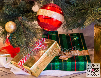 Decorative Santa Claus sleigh with colored gifts boxes under christmas tree.