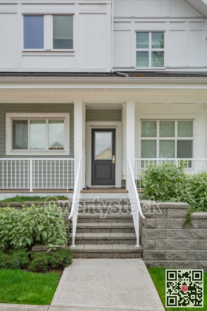 Entrance of residential unit under the porch with doorsteps in front