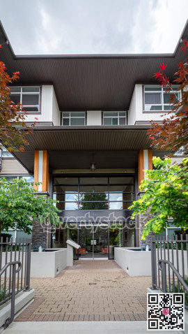 Entrance of new residential building with paved area in front