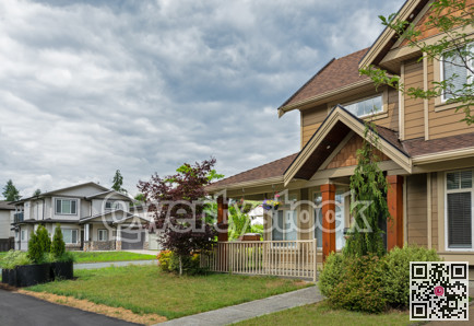 Street view in suburban residential area on cloudy sky background