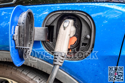 Electric plug of charging station connected to a vehicle for battery recharge