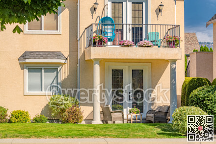 Fragment of luxury residential townhouse facade on bright summer day