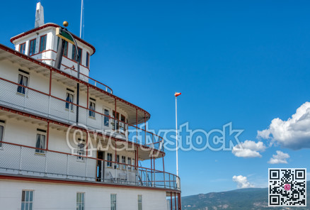 Upper decks of steam vessel on blue sky background