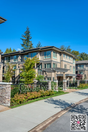 Row of residential townhouses on blue sky background
