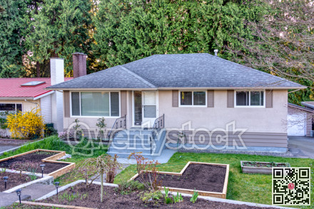 Residential family house with wooden garden beds on the front yard