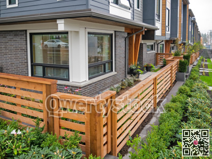 Wooden fence in front of new residential townhouse on foggy day