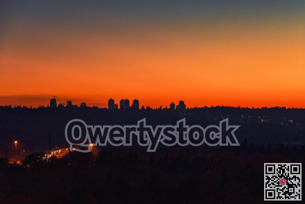 Urban cityscape silhouette on sunset sky background