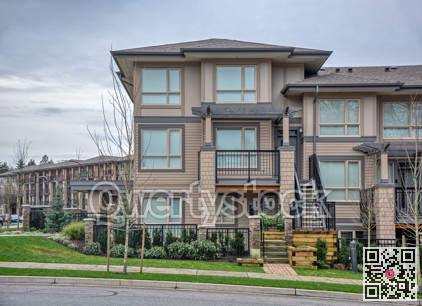 Residential townhouses on overcast sky background with walking pathway in front