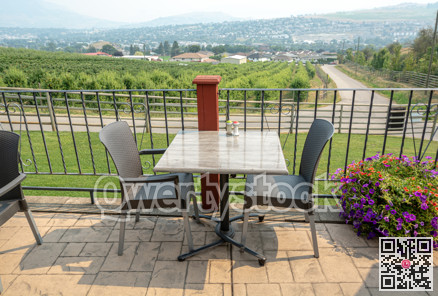 Street cafe table and chairs with smoky Okanagan valley overview